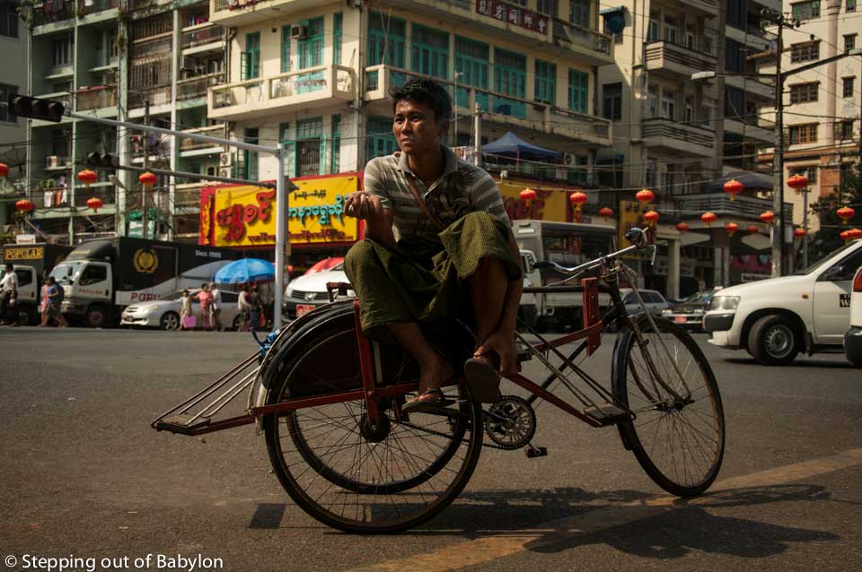Yangon... where the rickshaw drivers wait quietly indifferent to the busy traffic of the city, chewing paan or smoking a cigar.