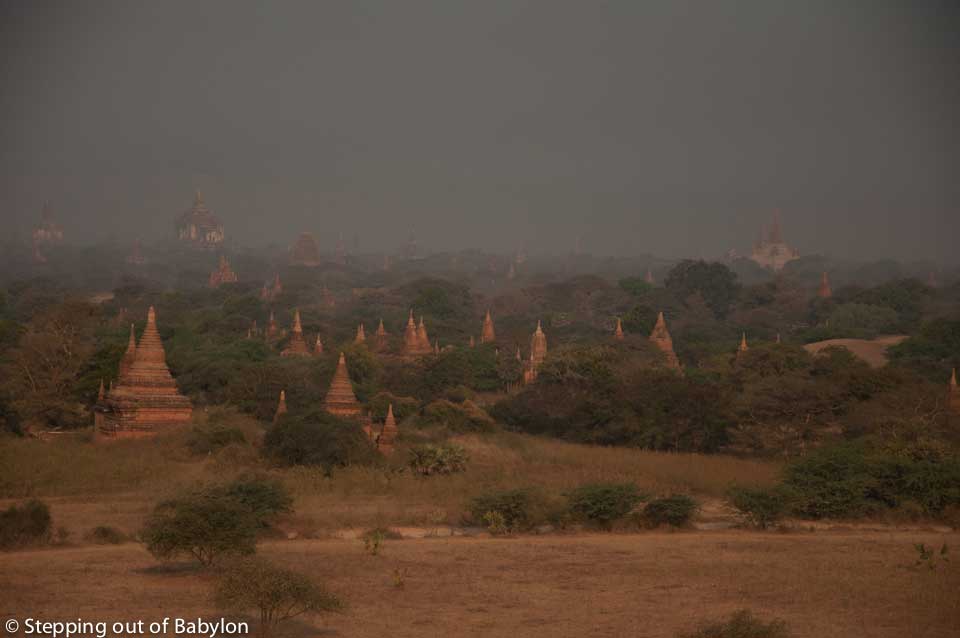During the afternoon the landscape is wrapped in a layer of mist resulting from the heat. Bagan, Myanmar