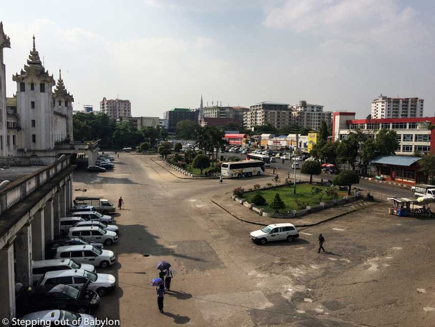 To buy bus ticket in Yangon: on the ledt side is the train station and on the right side are located the offices from ticket agents and bus companies