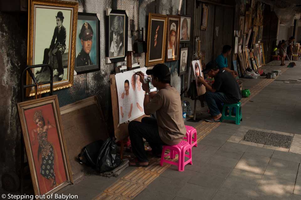 many painters working on the canvas or simply selling paintings along Jalan Pintu Besar Selatan