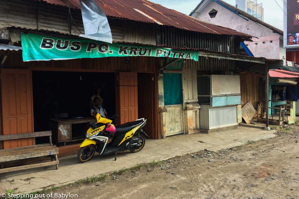 the P.O. Krui Putra “office”, nearby the roundabout with the fish statue, just next to the “Dua A” warung)