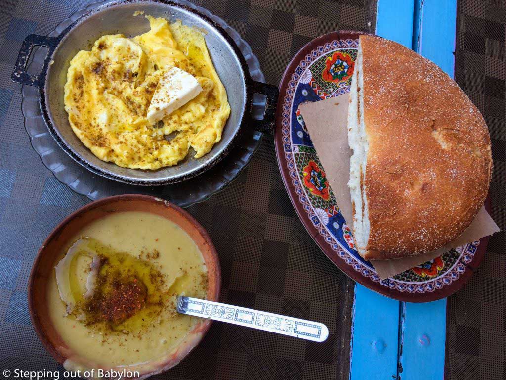 delicious breakfast at Ouarzazate main square... forget the western breakfast standards and enjoy this strong local brekafast with soup, bread and eggs... the triangle cheese is a trace of the french presence in Morocco